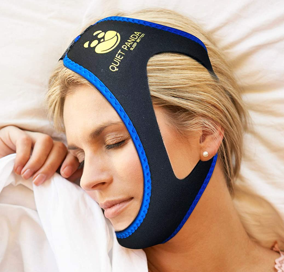 Woman sleeping while wearing a Quiet Panda Chinstrap to prevent snoring