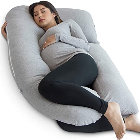 Pregnant woman sleeping with a body pillow 