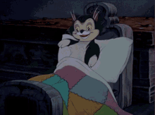 Gif of a cartoon cat wiggling himself into bed for sleep