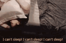 A gif of a woman freaking out in bed because she cant sleep and she hates everything