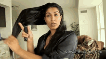 Woman brushing her long black and shiny hair