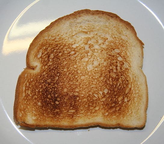 One piece of toast on a white plate