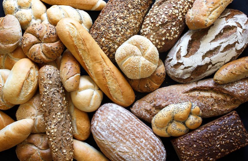 Different types of bread, from bread sticks to rolls, to loads piled on top of each other