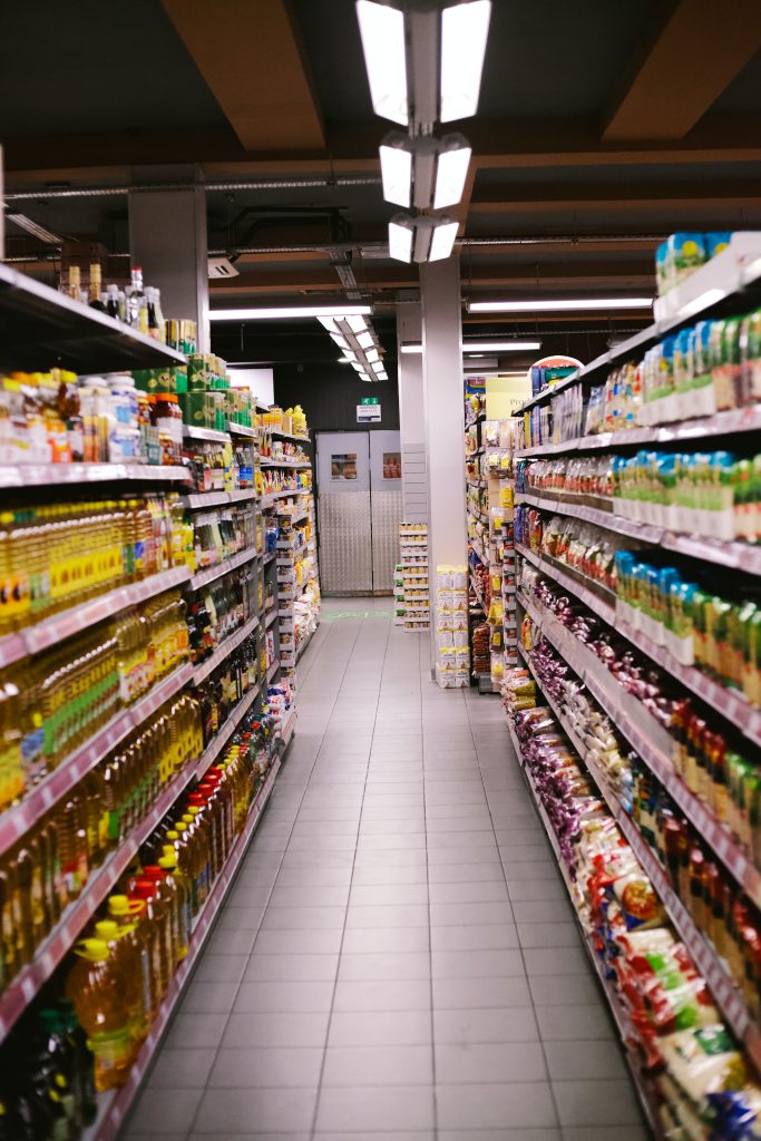 Aisle of the grocery store with lots of food stocked on shelves