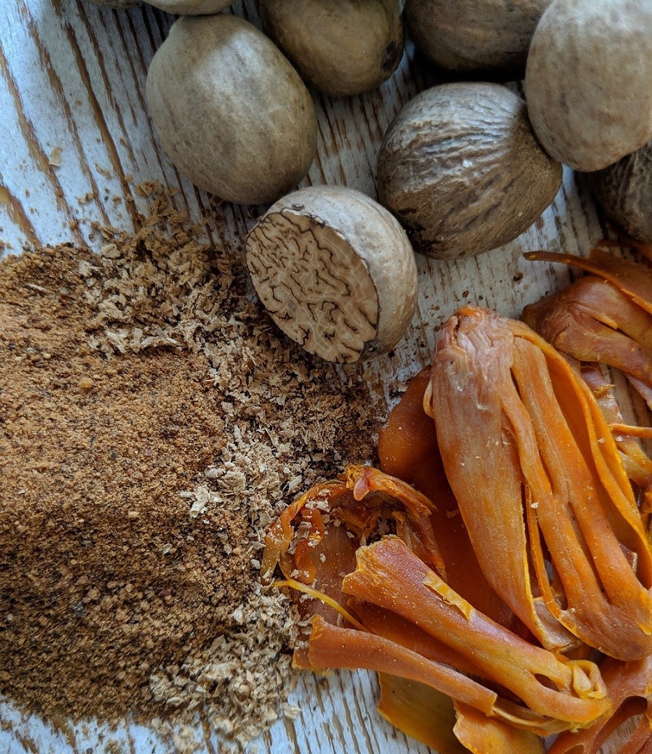 Nutmeg in various forms— powder, seed, and shredded orange stuff
